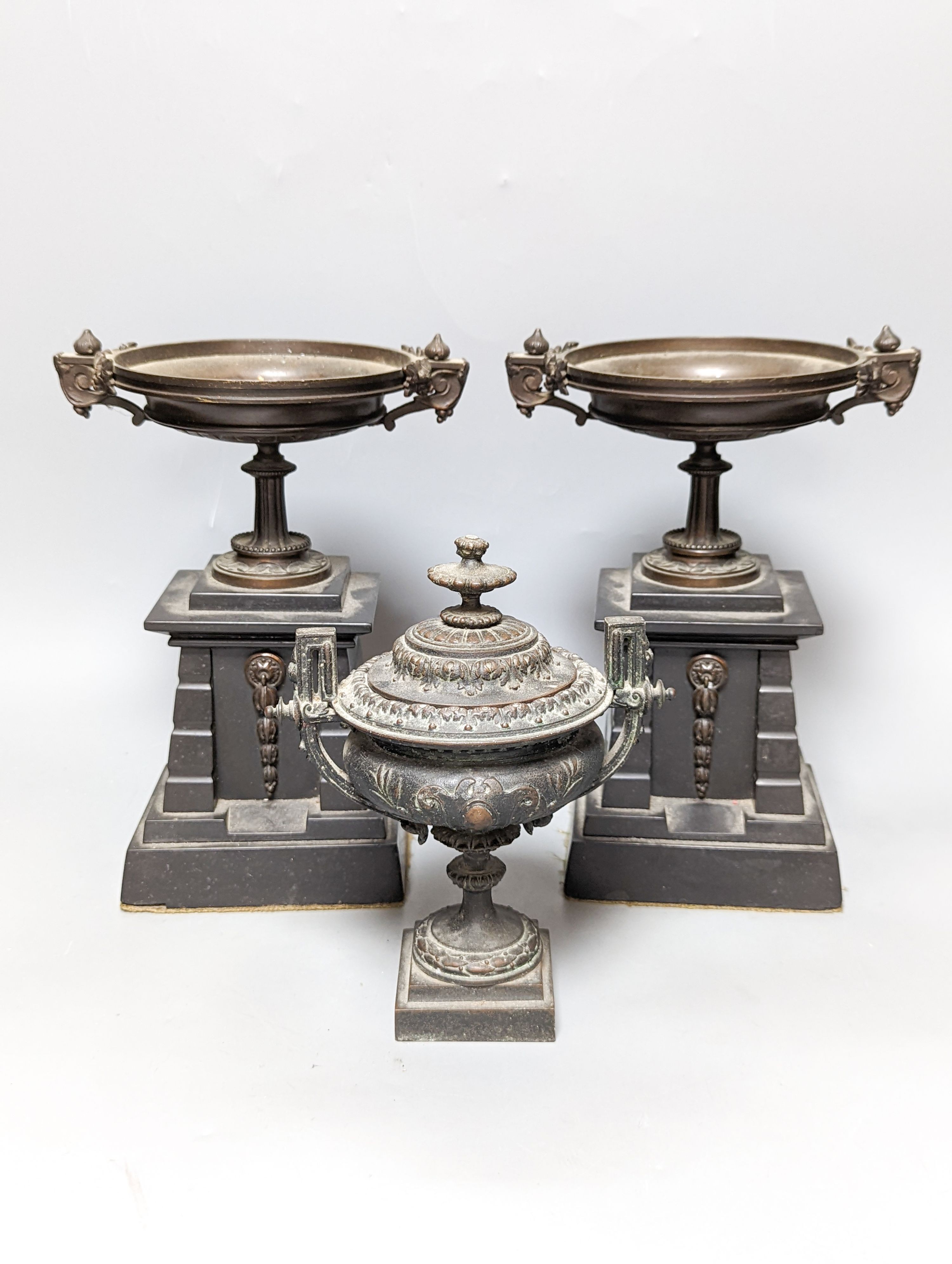 A pair of bronze tazzas on architectural slate bases, c.1900, together with a third, associated piece (3) 25cm